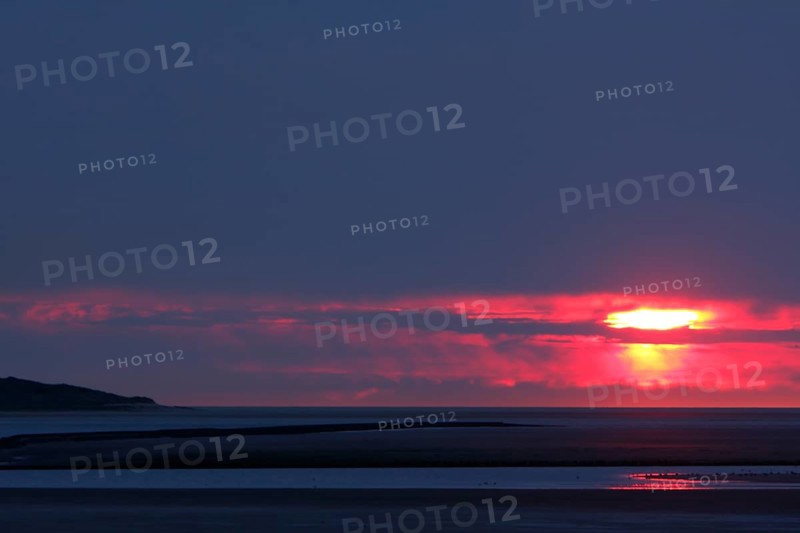 View from the island of Minsener Oog to Wangerooge at sunset
