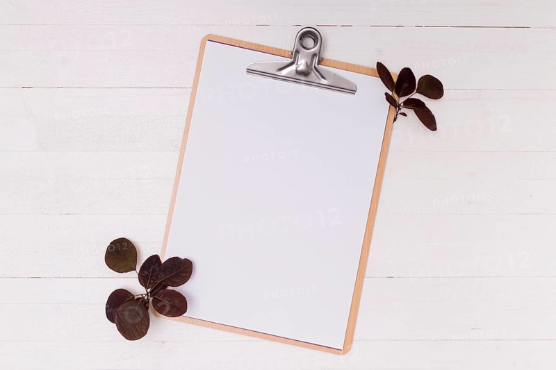 Dried leaves with white mock up clipboard