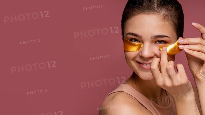 Beautiful woman using eye patch masks
