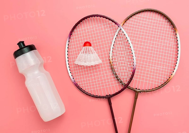 Flat lay badminton set with water bottle