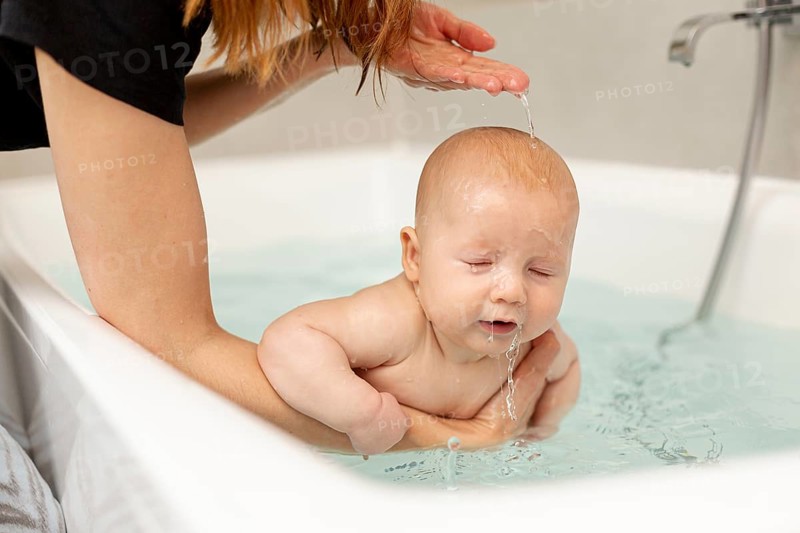 Close up mother washing her baby