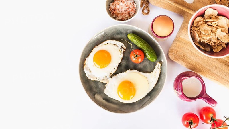 Fried omelette with tomato cucumber plate white background