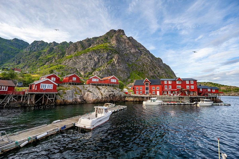 Traditional red rorbuer wooden cabins with stockfish museum