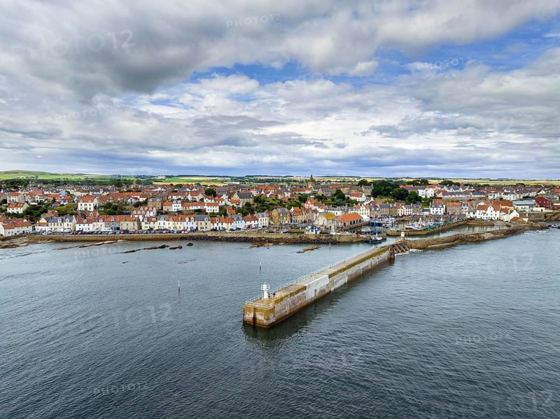 Aerial view of the fishing village of Pittenweem on the Firth of Forth with quay wall and lighthouse