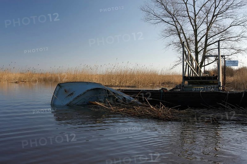 Capsized boat at the jetty of the Lower Weser island Strohauser Plate after a storm surge