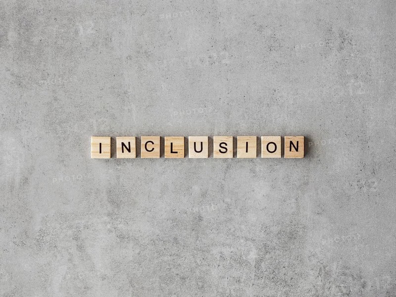 Inclusion word written scrabble letters marble background