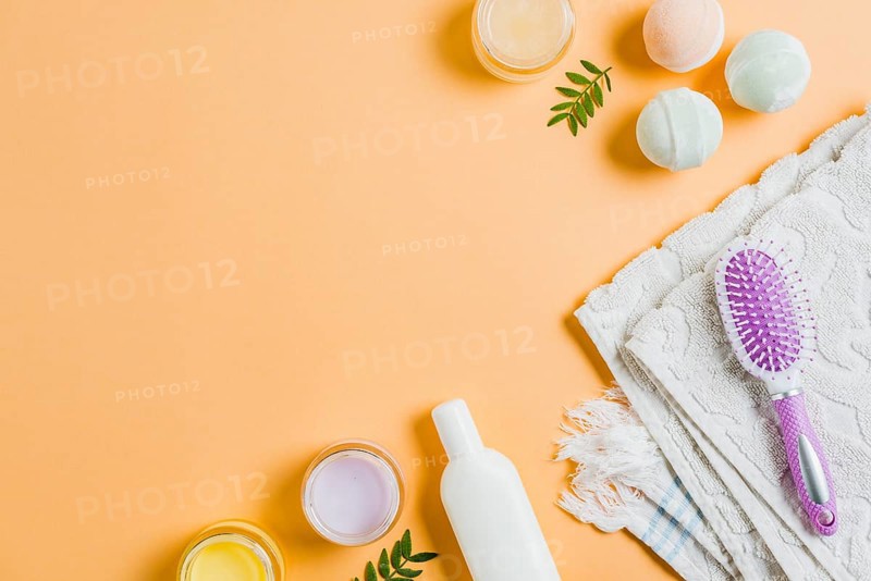 Towel moisturizers hairbrush bath bomb colored background