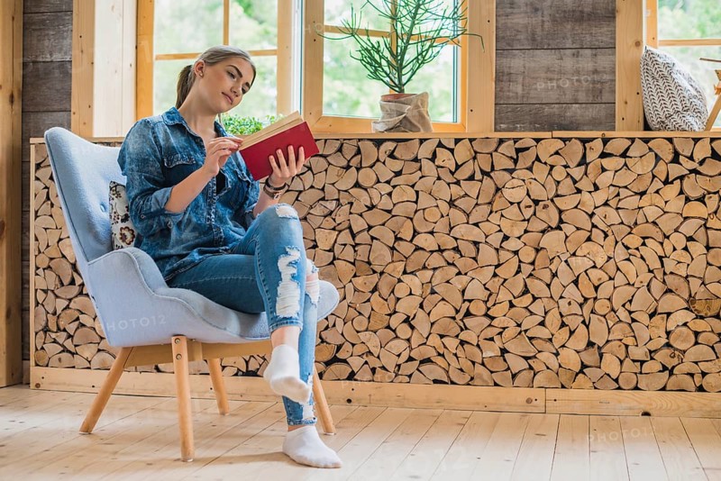 Classy young woman looking book
