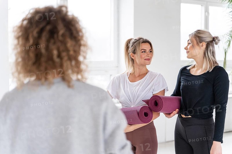 Women holding yoga mats