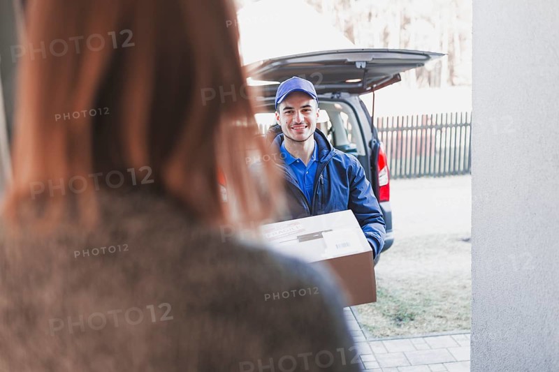 Woman greeting deliveryman porch