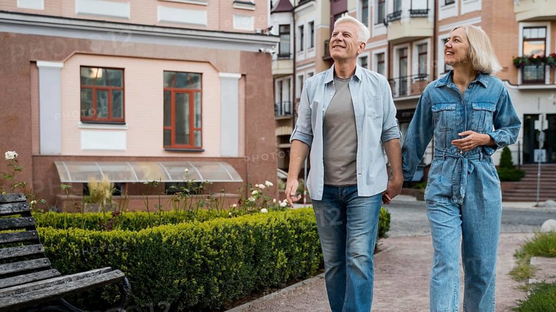Front view if older couple holding hands city