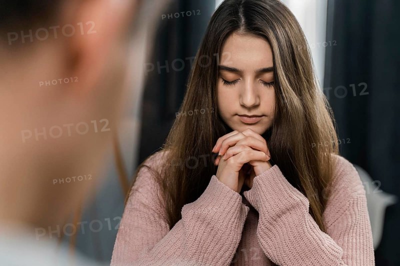 People praying home before dinner