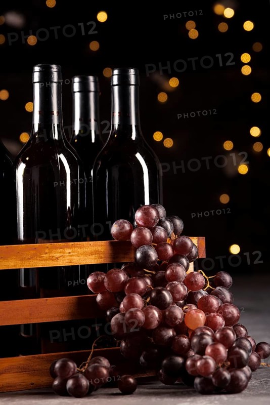 Set wine bottles grapes with bokeh background