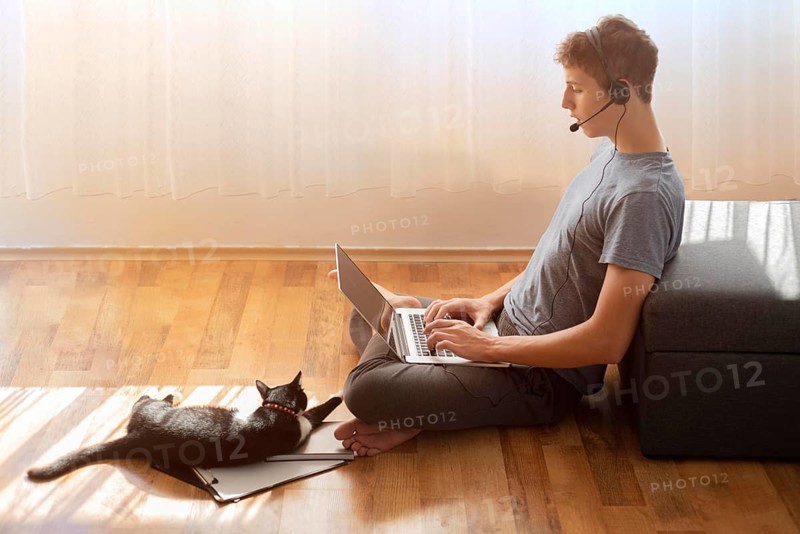 Side view man using laptop home quarantine work