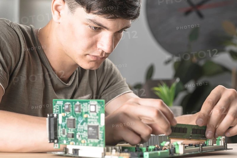 It technician students inserting ram computer motherboard