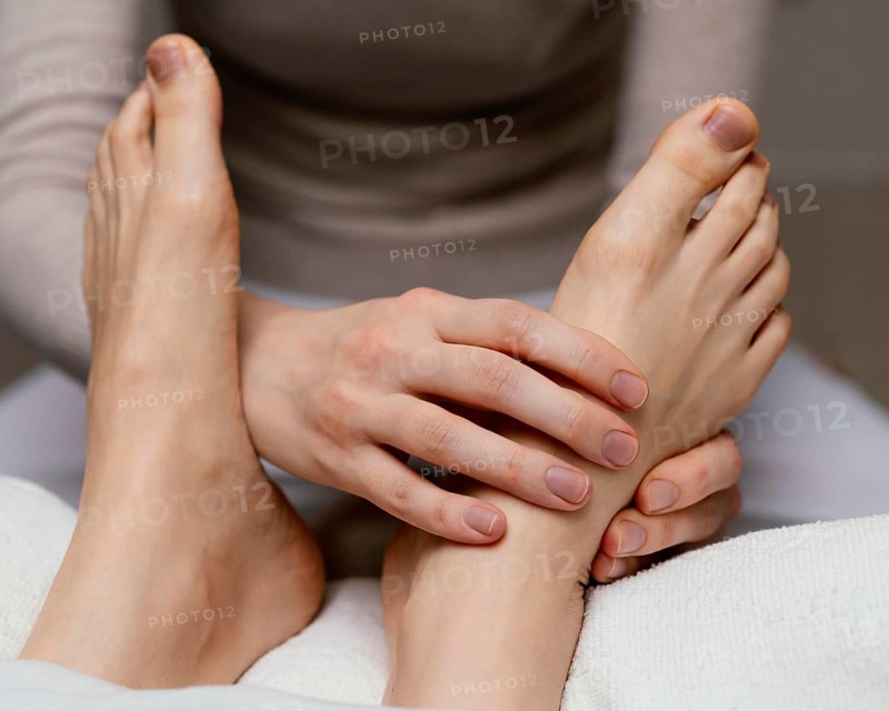 Close up therapist massaging foot