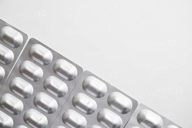 Overhead view silver pills blister pack white background