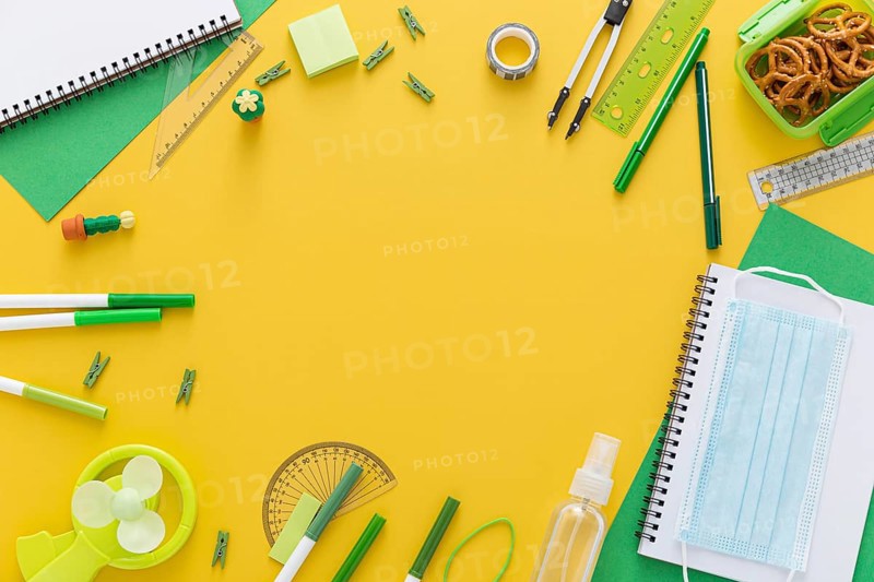 Flat lay back school materials with notebook face mask