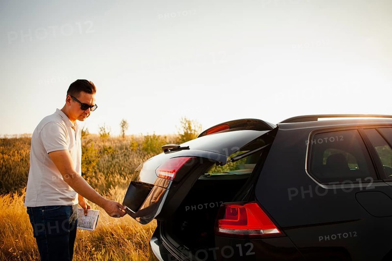 Young man opening trunk