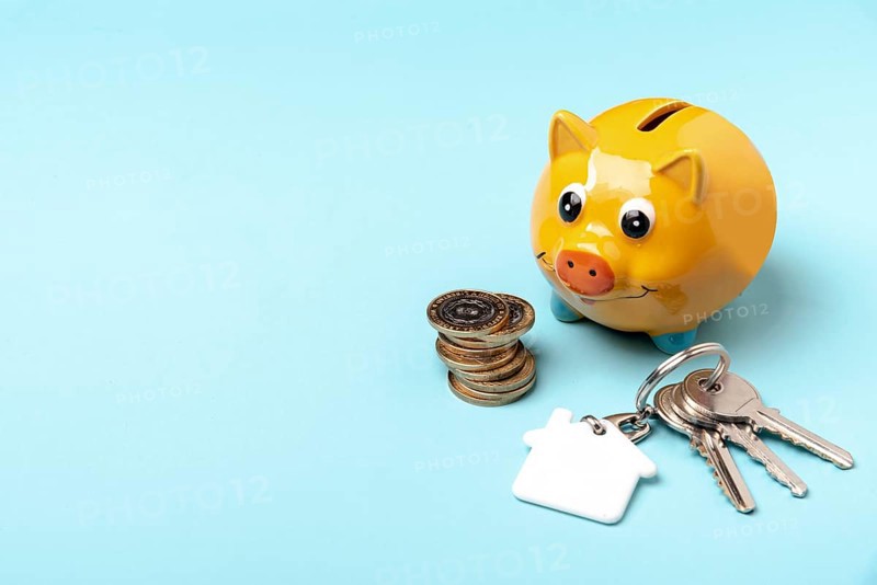 Yellow piggy bank with keys copy space background