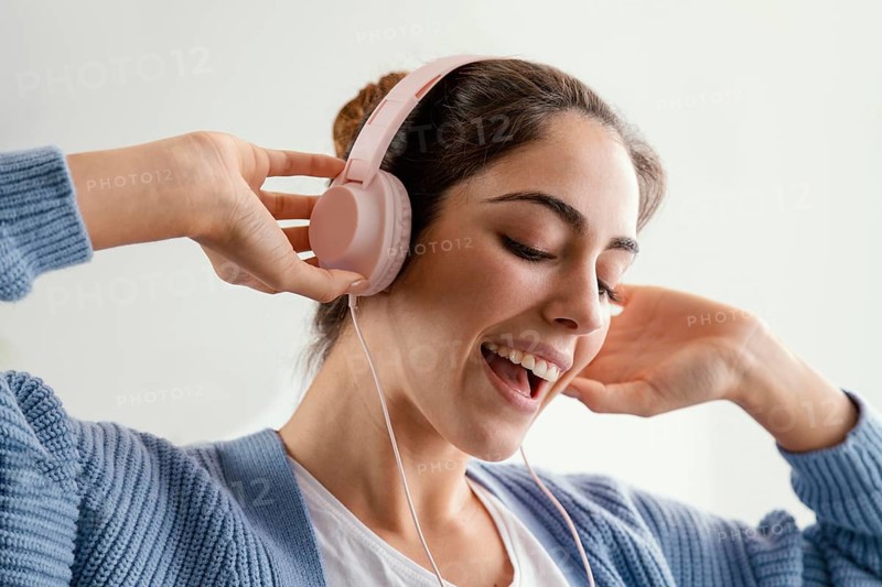 Smiley woman listening music headphones