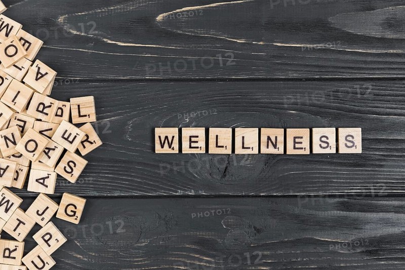 Wellness word wooden background