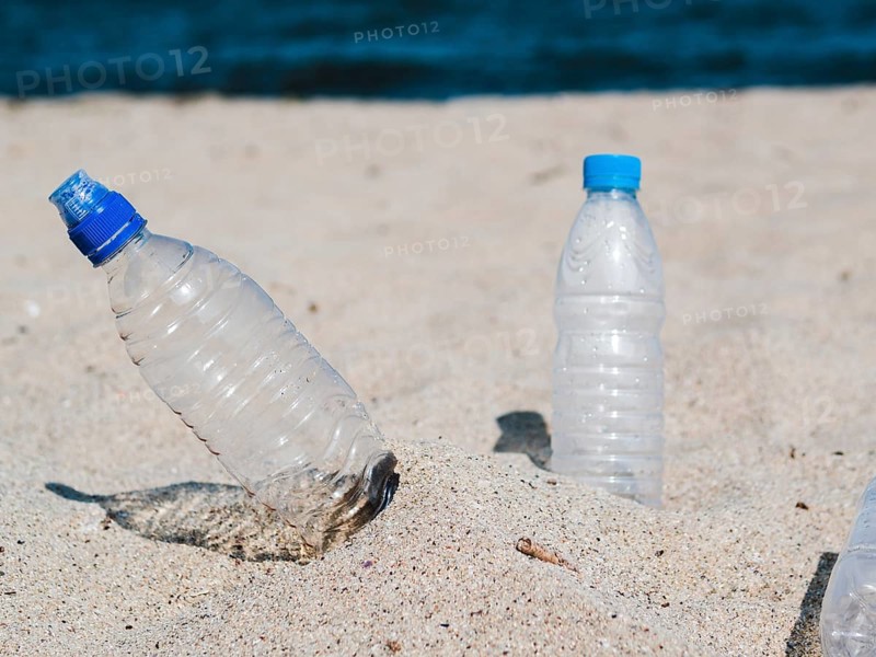 Empty plastic water bottle sand beach