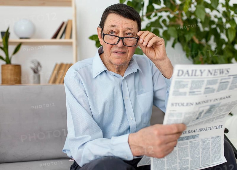 Medium shot man holding newspaper