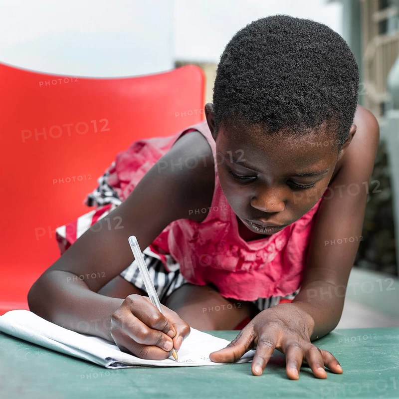 Medium shot girl writing notebook