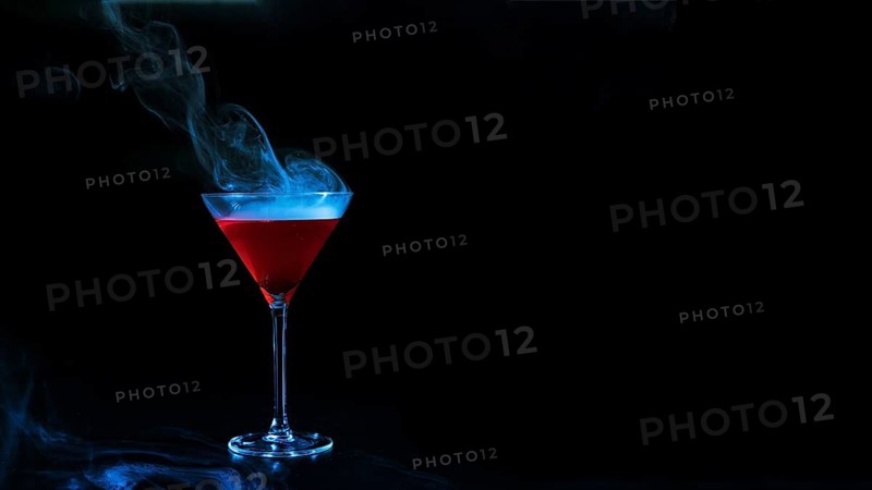 Wineglass with red smoky liquid