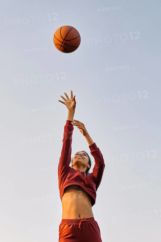 Young woman playing basketball