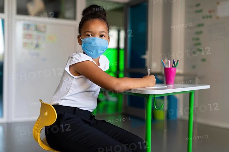 Little girl using medical mask class