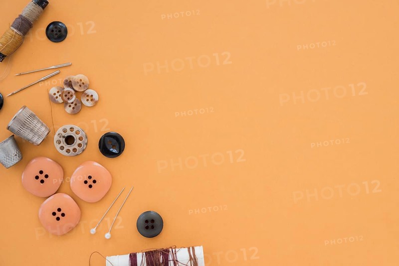 Thread buttons needle thimble colored backdrop