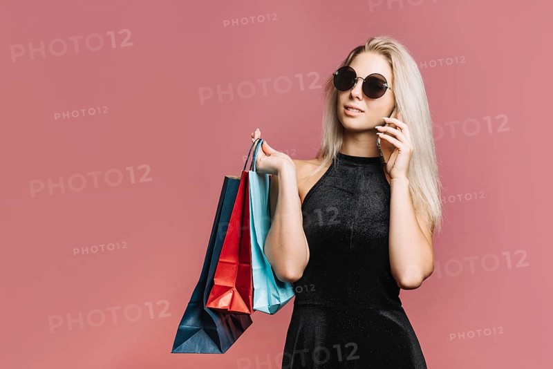 Stylish shopper talking smartphone