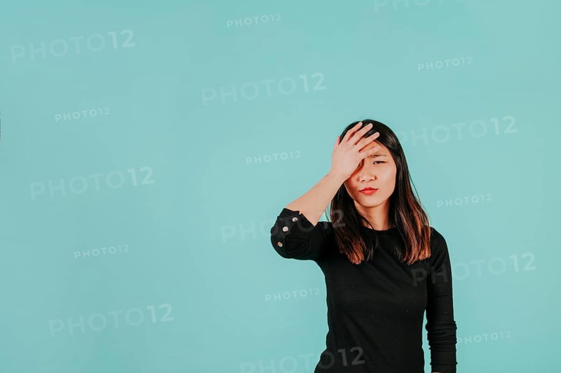 Facepalming asian woman