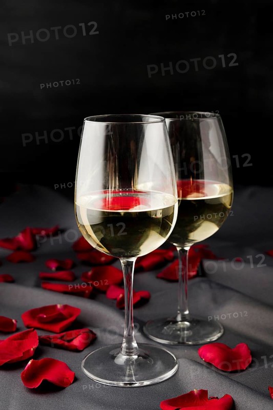 Valentine s day rose petals with wine glasses