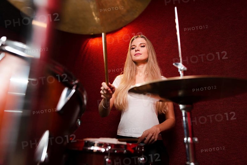 Low view shot girl playing cymbals