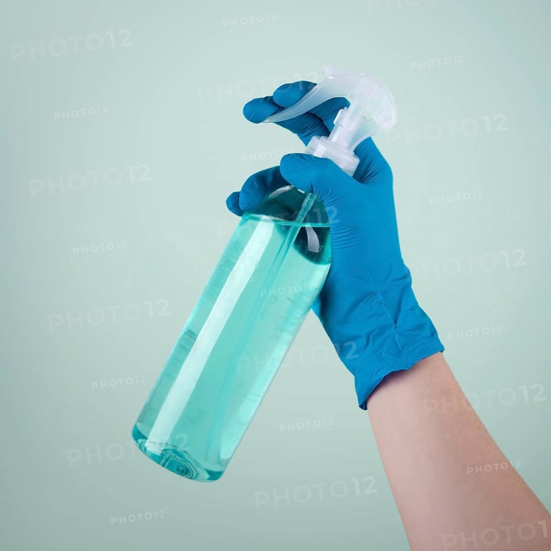 Hand with surgical glove using disinfectant