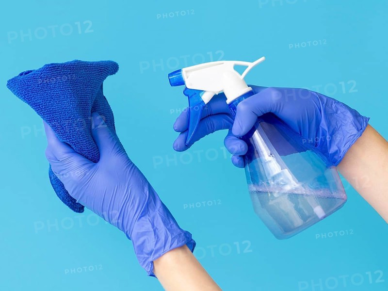 Hands with surgical gloves holding cloth ablution