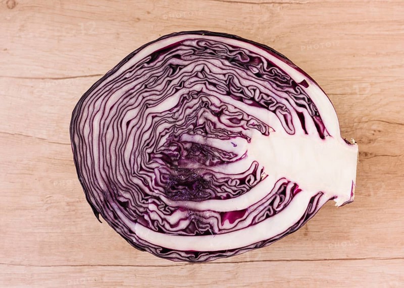 Halved red cabbage wooden background