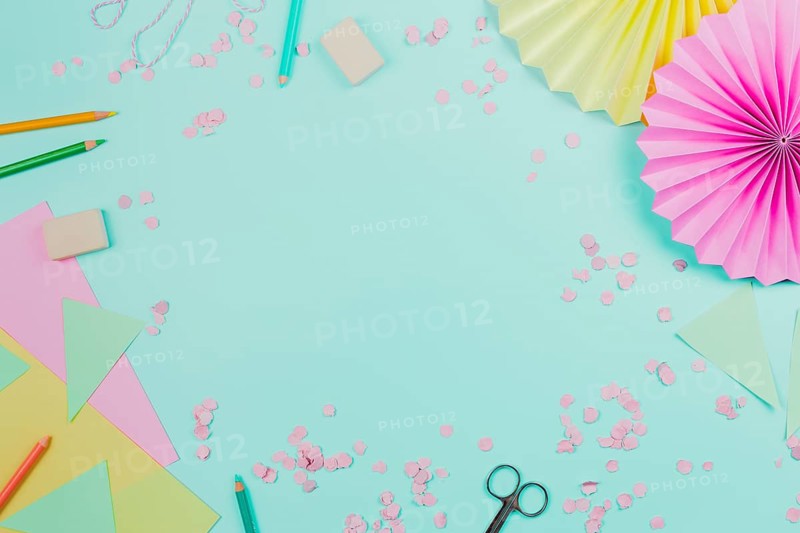 Circular paper fan with confetti colored pencils teal background