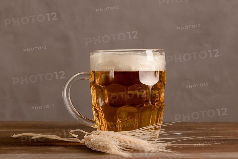 Mug light beer with wheat wooden table