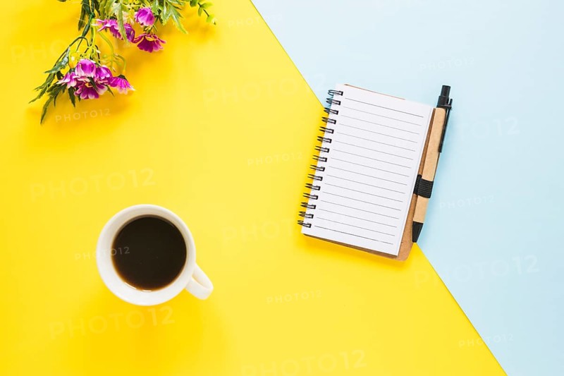 Workplace with notebook cup