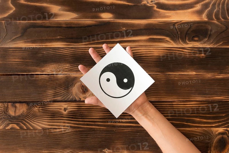 Top view hand holding ying yang symbol
