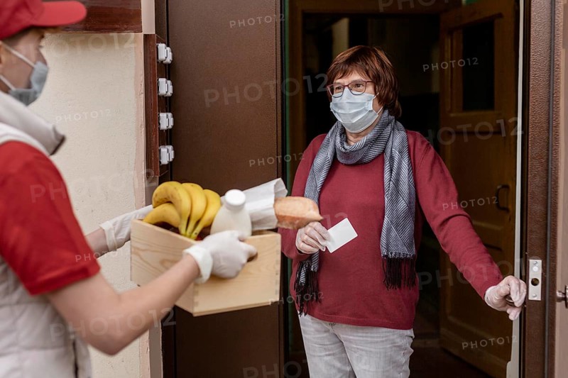 Close up man carrying crate food