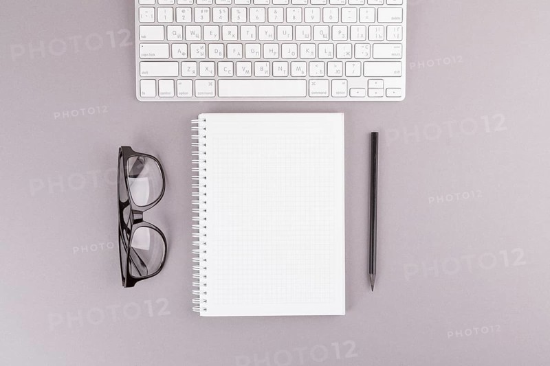 Pencil near notebook keyboard eyeglasses