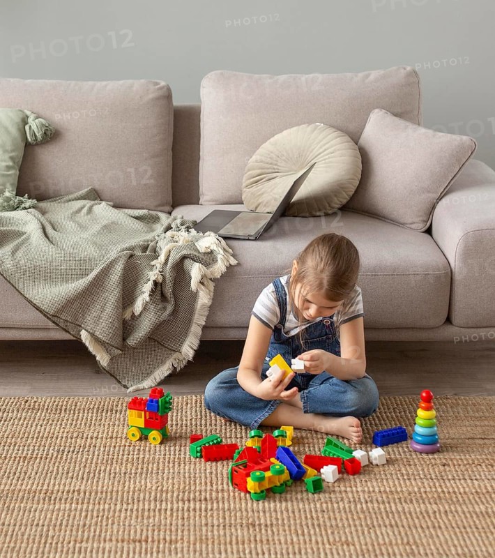 Full shot kid playing floor