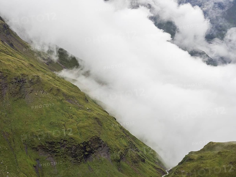 Morning fog drifts over a mountain ridge