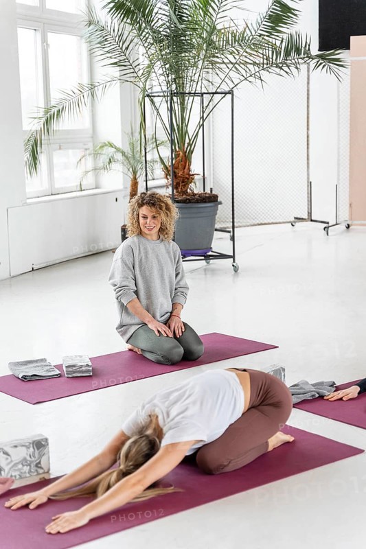 Full shot woman yoga mat stretching