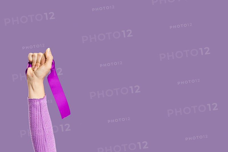 Woman s hand holding violet ribbon copy space